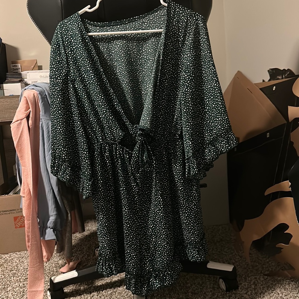 Green and white polka dot romper with a cut out in front!